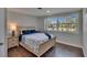Bright bedroom featuring a large window, wood floors, and coastal-themed decor at 733 S Clayton Ave, Lakeland, FL 33801