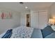 Bedroom with nautical themed quilt, closet with sliding doors, and a view to the bathroom at 733 S Clayton Ave, Lakeland, FL 33801