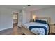 Bedroom with a wooden-framed bed, coastal-themed bedding, and a view to the entry door at 733 S Clayton Ave, Lakeland, FL 33801