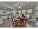 Bright dining area featuring a chandelier, hardwood floors, and large windows bringing in natural light at 733 S Clayton Ave, Lakeland, FL 33801