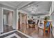 Elegant dining room with hardwood floors, chandelier, and adjacent kitchen area at 733 S Clayton Ave, Lakeland, FL 33801