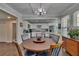 Charming dining area with hardwood floors, leading to a modern white kitchen at 733 S Clayton Ave, Lakeland, FL 33801