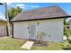 Exterior view of a detached garage with white siding and a door, set against a well-maintained lawn at 733 S Clayton Ave, Lakeland, FL 33801