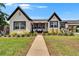 Charming two-story home featuring a well-manicured lawn and beautiful landscaping at 733 S Clayton Ave, Lakeland, FL 33801