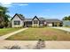 Charming two-story home with landscaped yard, bright white exterior, and covered carport at 733 S Clayton Ave, Lakeland, FL 33801