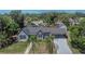 Charming home featuring a manicured lawn, a covered carport, and delightful palm trees at 733 S Clayton Ave, Lakeland, FL 33801