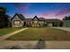 Beautiful home exterior with a well-manicured lawn, covered parking and mature landscaping on a colorful evening at 733 S Clayton Ave, Lakeland, FL 33801