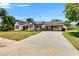 Charming home with white exterior, dark trim, covered parking, and well-manicured landscaping at 733 S Clayton Ave, Lakeland, FL 33801