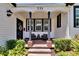 Charming front porch with brick floor and comfortable seating arrangement at 733 S Clayton Ave, Lakeland, FL 33801