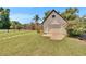 Detached garage with a well-maintained lawn and surrounded by greenery at 733 S Clayton Ave, Lakeland, FL 33801