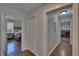 Hallway with access to the main bedroom, a closet and the laundry room, featuring hardwood floors at 733 S Clayton Ave, Lakeland, FL 33801