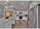 Kitchen features stainless steel appliances, white cabinets, granite countertops, and wood-look floors at 733 S Clayton Ave, Lakeland, FL 33801