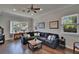 Cozy living room with hardwood floors, a ceiling fan, and ample natural light at 733 S Clayton Ave, Lakeland, FL 33801
