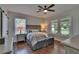Bedroom featuring hardwood floors, neutral color palette, and large windows allowing ample natural light at 733 S Clayton Ave, Lakeland, FL 33801