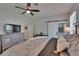 Spacious bedroom with ceiling fan, gray walls and luxury furniture; bathroom is attached with sliding door at 733 S Clayton Ave, Lakeland, FL 33801