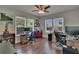 Well-lit office with hardwood floors, multiple windows and workspaces for two people at 733 S Clayton Ave, Lakeland, FL 33801