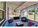 Relaxing screened-in patio features outdoor seating, brick flooring and overhead string lights at 733 S Clayton Ave, Lakeland, FL 33801