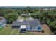 View of home featuring a spacious yard, screened in patio, and a convenient carport at 733 S Clayton Ave, Lakeland, FL 33801