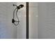 Modern shower with white subway tile, black fixtures, and niche for toiletries at 733 S Clayton Ave, Lakeland, FL 33801