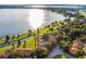 Aerial view showcasing lakefront residential community with green spaces, mature trees, and convenient access to the main road at 804 Magnolia Pl # 804, Winter Haven, FL 33884