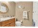 Well-lit bathroom featuring a wood vanity with a granite countertop and decorative accents at 804 Magnolia Pl # 804, Winter Haven, FL 33884