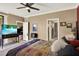 This primary bedroom features a ceiling fan and an ensuite bathroom for comfortable and private living at 804 Magnolia Pl # 804, Winter Haven, FL 33884