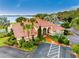 Aerial view of a well-maintained clubhouse with lush landscaping, convenient parking and appealing entryway at 804 Magnolia Pl # 804, Winter Haven, FL 33884