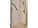 Shower stall featuring a glass door, grab bar, tiled walls, and a shower head at 804 Magnolia Pl # 804, Winter Haven, FL 33884