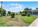 Expansive backyard with mature trees, partial fence, and glimpse of screened-in pool at 900 Howard Nw Ter, Winter Haven, FL 33881