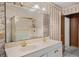 Bathroom featuring double sinks, shower, floral wallpaper and tile flooring at 900 Howard Nw Ter, Winter Haven, FL 33881