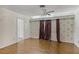 Bright bedroom with parquet floors, floral wallpaper, and ample natural light at 900 Howard Nw Ter, Winter Haven, FL 33881