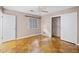 Bedroom featuring neutral walls, window, closet, and parquet floors at 900 Howard Nw Ter, Winter Haven, FL 33881
