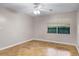 Bedroom featuring parquet floors, neutral walls, large window and ceiling fan at 900 Howard Nw Ter, Winter Haven, FL 33881