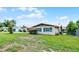 Lovely home featuring green shutters, well-kept landscaping, and a metal roof at 900 Howard Nw Ter, Winter Haven, FL 33881