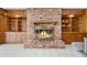 Cozy brick fireplace with built-in shelves and cabinets, perfect for a relaxing atmosphere at 900 Howard Nw Ter, Winter Haven, FL 33881