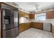 Spacious kitchen featuring stainless steel refrigerator, ample counter space, and tile flooring at 900 Howard Nw Ter, Winter Haven, FL 33881