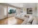 Bright living room featuring a large window, tile flooring, and a spacious sofa at 900 Howard Nw Ter, Winter Haven, FL 33881