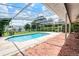 Backyard pool with screened in porch and brick patio at 900 Howard Nw Ter, Winter Haven, FL 33881
