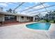 Backyard pool with covered lanai, brick patio, and ample space for outdoor entertaining at 900 Howard Nw Ter, Winter Haven, FL 33881