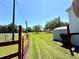 Expansive backyard with grass, a shed, and a fence, perfect for outdoor activities at 9625 Moore Rd, Lakeland, FL 33809