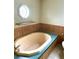 Bathroom showcasing an oval bathtub and an octagonal window, creating a unique and tranquil bathing space at 9625 Moore Rd, Lakeland, FL 33809