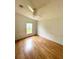 Bright bedroom with ceiling fan and hardwood flooring, creating a relaxing space at 9625 Moore Rd, Lakeland, FL 33809