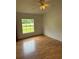 Bedroom with wood floor and one window at 9625 Moore Rd, Lakeland, FL 33809