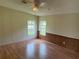 Bedroom with two windows and wood floor at 9625 Moore Rd, Lakeland, FL 33809