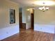 Inviting dining area featuring wood-style floors, wainscoting, and a stylish chandelier at 9625 Moore Rd, Lakeland, FL 33809