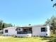 Charming single-story home with a front porch and well-maintained lawn, perfect for Gathering living at 9625 Moore Rd, Lakeland, FL 33809
