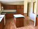 Traditional kitchen featuring wooden cabinets, an island, and laminate flooring at 9625 Moore Rd, Lakeland, FL 33809