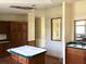 Spacious kitchen area with wooden cabinets, an island, and bright natural light at 9625 Moore Rd, Lakeland, FL 33809