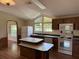 Bright kitchen with vaulted ceiling features white appliances, a double island, and many windows at 9625 Moore Rd, Lakeland, FL 33809
