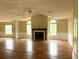 Inviting living room with a cozy fireplace, large windows, and laminate flooring at 9625 Moore Rd, Lakeland, FL 33809